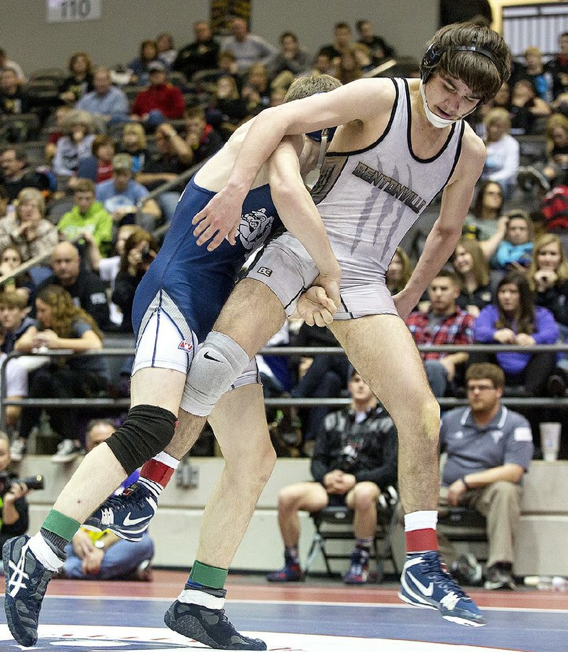 Aaron Grigsby (front) of Bentonville wrestles Caleb Erskine from Greenwood on Saturday during the State Wrestling Championships at Jack Stephens Center in Little Rock. 