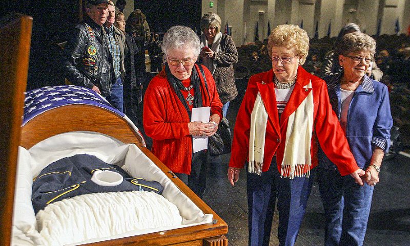 Geraldean Johnson (center), the widow of U.S. Army Cpl. C.G. Bolden, with her sister Nina Eubanks (left) and her niece Lois Jones pass Bolden’s casket Saturday before his memorial service. 