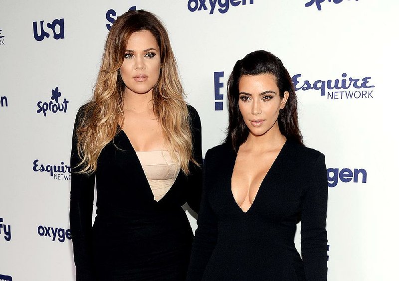 In this May 15, 2014 file photo, Khloe Kardashian, left, and Kim Kardashian arrive at the NBCUniversal Cable Entertainment 2014 Upfront at the Javits Center in New York. Khloe and Kim Kardashian are safe after the vehicle they were in slid off a Montana road and into a ditch on Saturday, Feb. 21, 2015.  