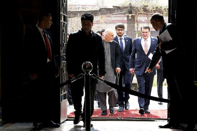 U.S. Defense Secretary Ashton Carter (second from right) arrives at a news conference Saturday with Afghan President Ashraf Ghani in Kabul. It is Carter’s first international visit since becoming defense secretary. 