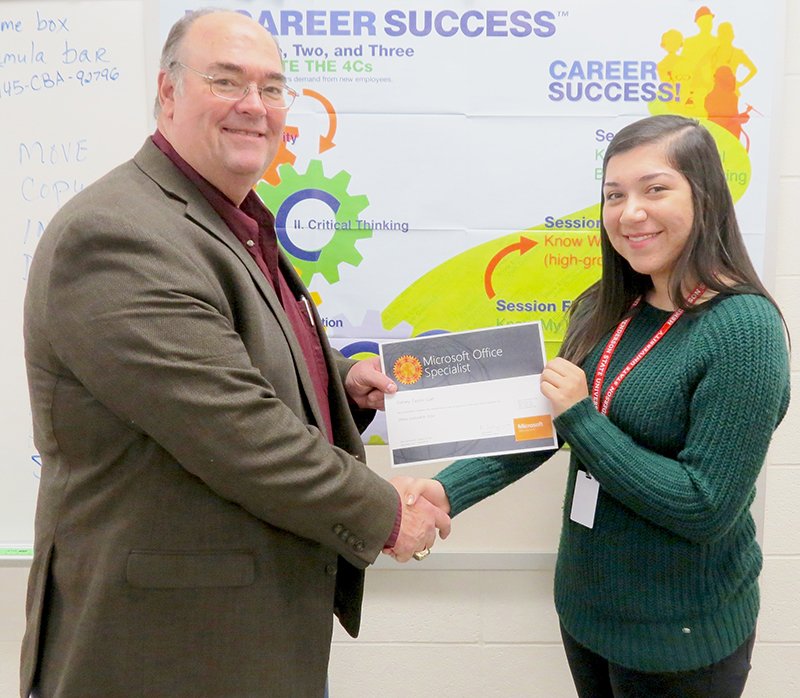 Submitted photo Specialist certification: Steve Anderson, superintendent of the Lake Hamilton School District, presents Sidney Galt her Microsoft Office Specialist certification during the CBA class.
