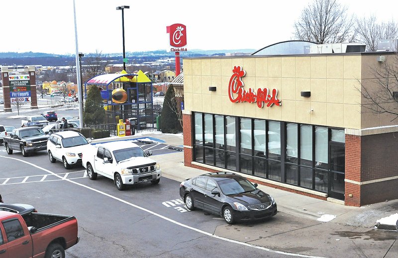 NWA Democrat-Gazette/FLIP PUTTHOFF Diners use the drive-through Thursday at Chick-fil-A at 4180 N. College Ave. in Fayetteville Chick-fil-A is one of the top tax-paying restaurant in Fayetteville for the fourth straight year.