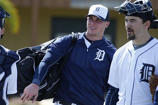 Detroit Tigers catcher James McCann, center, finishes a baseball spring training workout in Lakeland, Fla., Saturday, Feb. 21, 2015. (AP Photo/Gene J. Puskar)