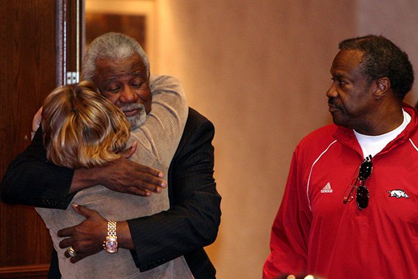 Former Arkansas head coach Nolan Richardson, left, is greeted by former secretary Terry Mercer as Robb Evans watches on Tuesday, Jan. 29, 2008, at the Holiday Inn Convention Center in Springdale. 