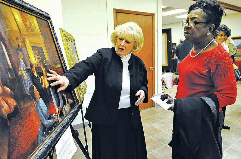 Fayetteville artist Dee Dee Lamb talks about her painting with Verda Watson on Sunday during Compassion Fayetteville’s Black History Celebration Day at St. James Missionary Baptist Church The event featured art, music and a reception. Lamb paints historic scenes of Civil War Fayetteville.