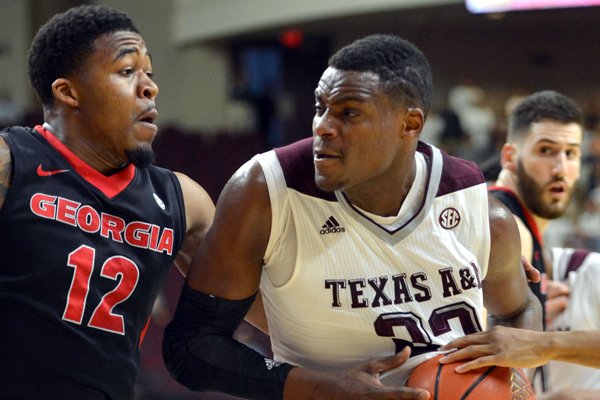 Texas A&M guard Danuel House (23) drives the lane against Georgia's Kenny Gaines (12) during the first half of a NCAA college basketball game at Reed Arena in College Station, Texas on Wednesday, Feb. 11, 2015. (AP Photo/College Station Eagle, Sam Craft)