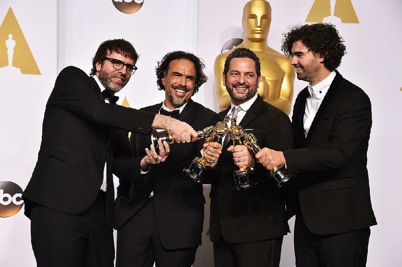 Nicolas Giacobone (from left), Alejandro Inarritu, Alexander Dinelaris and Armando Bo pose with their awards for Birdman, which won best picture at the Oscars on Sunday in Los Angeles. 