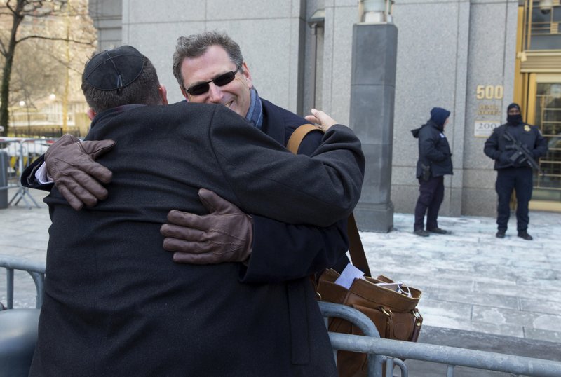 Attorney Kent Yalowitz, right, representing those affected by attacks in Israel in the early 2000s, hugs Mark Weiss of New York outside a federal courthouse in New York Monday, Feb. 23, 2015. The court found the Palestinian authorities liable in the attacks, with jurors awarding the victims $218.5 million in damages at a civil trial