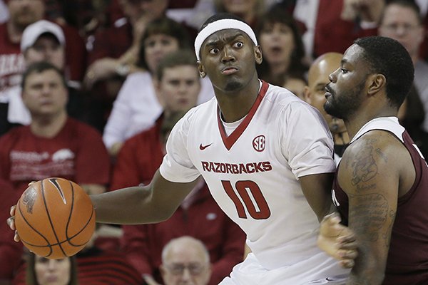 Arkansas's Bobby Portis (10) works the ball around Texas A&M's Kourtney Roberson in the first half of an NCAA college basketball game in Fayetteville, Ark., Tuesday, Feb. 24, 2015. (AP Photo/Danny Johnston)