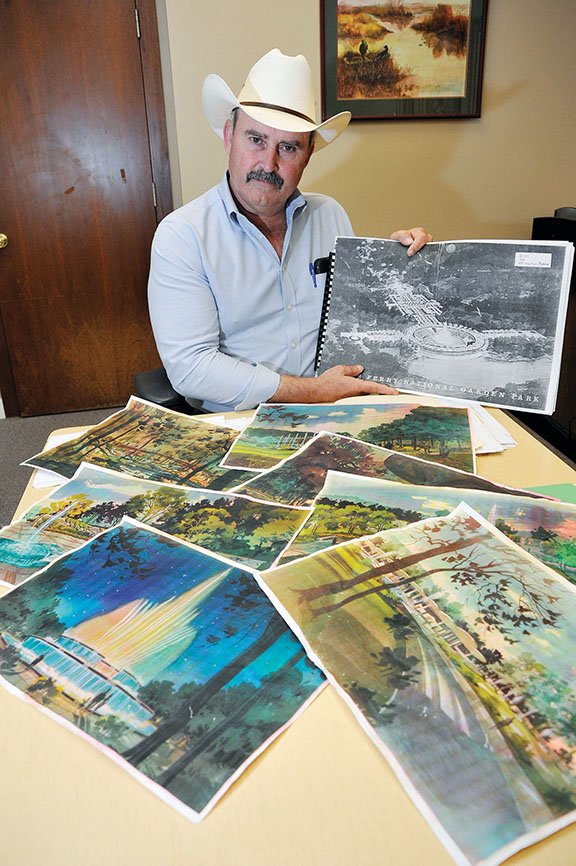 Cleburne County Judge Jerry Holmes, in this photo from July, holds a drawing from the 1960s for a water-garden project near the Greers Ferry Dam in Heber Springs. The project started in the 1960s with a Heber Springs businessman, who proposed the idea to his friend Sen. J. William Fulbright. President John F. Kennedy, at the dam dedication in 1963, gave the OK for the plans, but he was assassinated a few weeks later. The project was resurrected by Holmes and Billy Lindsey of Heber Springs, but officials for the U.S. Army Corps of Engineers said the project does not meet the mission of Greers Ferry Lake, per a 2005 national policy change.