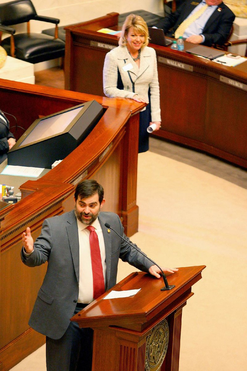 State Rep. Robin Lundstrum, R-Springdale (top), listens Tuesday as Rep. Chris Richey, D-Helena-West Helena, speaks about her bill abolishing the Arkansas Lottery Commission. 