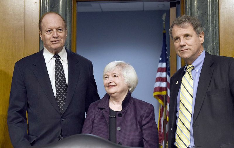 Senate Banking Committee Chairman Sen. Richard Shelby, R-Ala. (left), and the committee’s ranking member Sen. Sherrod Brown, D-Ohio, enter a hearing room on Capitol Hill on Tuesday with Federal Reserve Chairman Janet Yellen. 