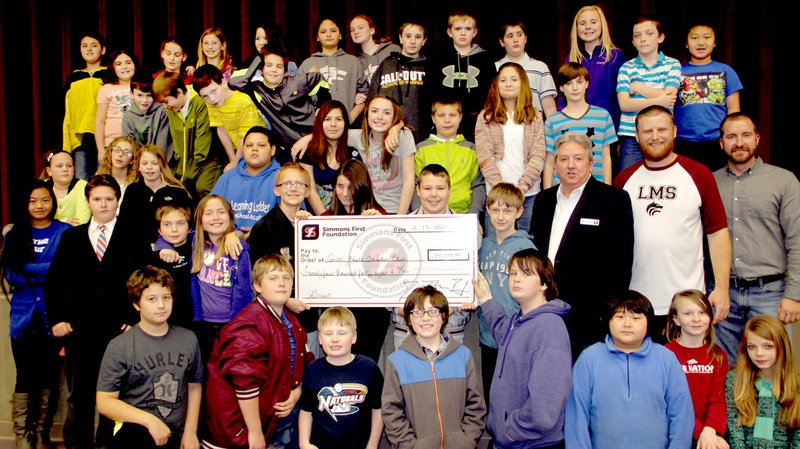 LYNN KUTTER ENTERPRISE-LEADER Simmons Bank of northwest Arkansas recently donated $24,048 to the Lincoln Youth Adventure Club for middle school students. The club meets Monday-Friday after school in the former band room. The students in the photo participate in the Adventure Club.