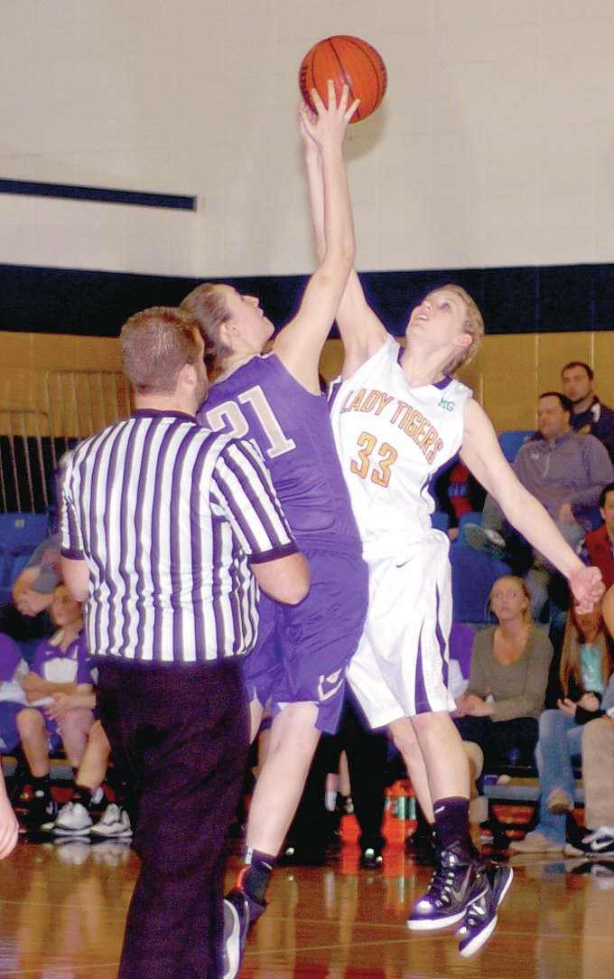 MARK HUMPHREY ENTERPRISE-LEADER Prairie Grove&#8217;s Ashley Cox jumps center against Berryville&#8217;s Ally Teague. Cox had 9 points and 3 rebounds as the Lady Tigers beat the Bobcats, 49-34, in the District 4A-1 girls basketball semifinal at Shiloh Christian School of Springdale.