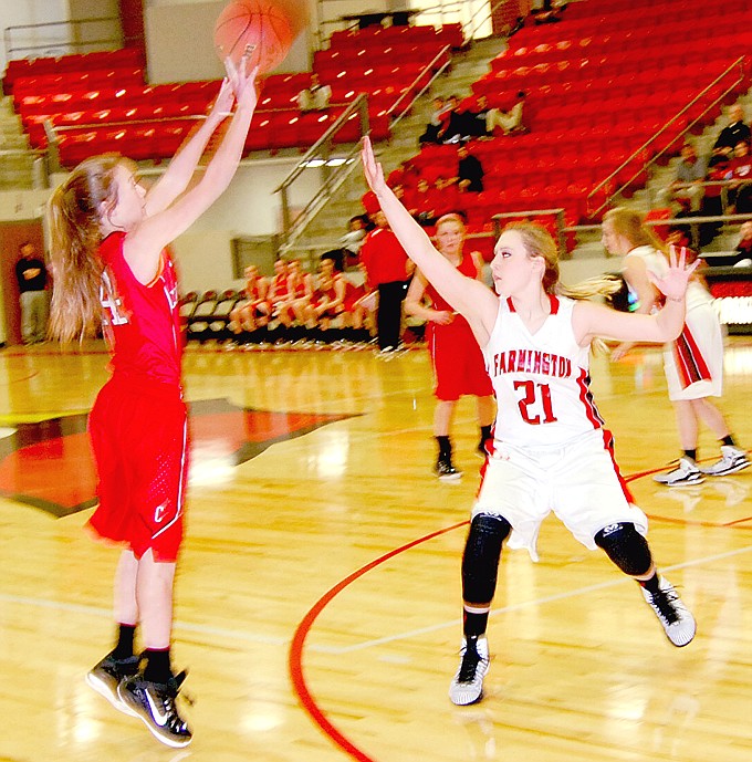 BEN MADRID ENTERPRISE-LEADER Farmington forward Tori Hamley jumps out to contest a shot against Clarksville. The Lady Cardinals defeated the Panthers, 50-40, on Feb. 18.