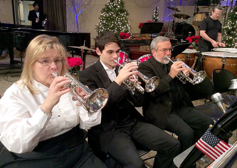 Photo submitted Ozark Mountains British Brass Band members, from left, Loree Todd, Alex Grisos, Richard Sees and Mike Van Ore performed during the Christmas concert at First Church of the Nazarene in Rogers. The 30 member band will be performing in at the Siloam Springs High School on March 1.