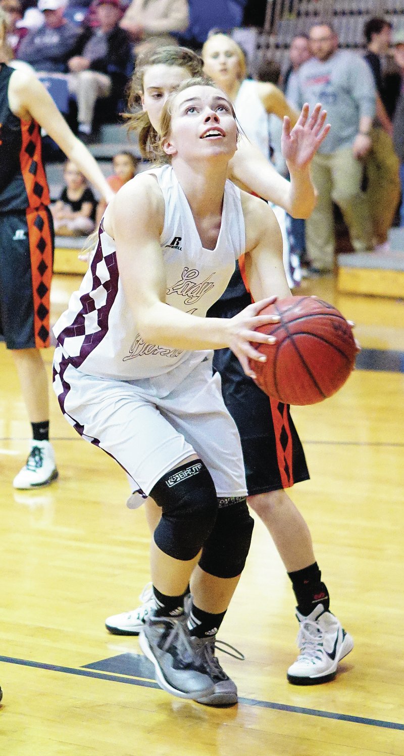 Photo by Randy Moll Haley Borgeteien-James, Gentry junior, sets to shoot for two under the basket during tournament play between Gentry and Gravette at Shiloh Christian in Springdale on Thursday.