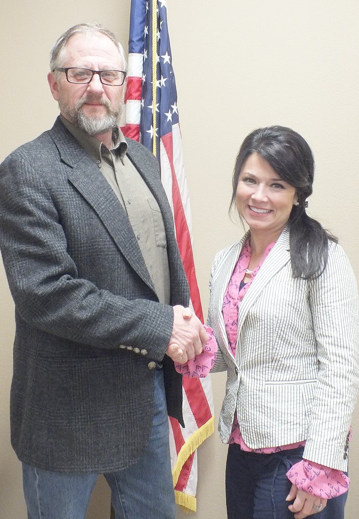 TIMES photograph by Annette Beard Garfield Mayor Gary Blackburn congratulates Mrs. Teresa Vining who was elected the new city recorder/treasurer by the City Council. Vining fills a void left by the unexpected resignation of Merlene Snoderly, who left Dec. 31.