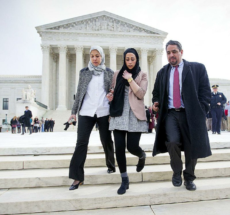 Samantha Elauf, (center) her mother, Majda Elauf, and P. David Lopez, general counsel for the Equal Employment Opportunity Commission, leave the Supreme Court on Wednesday after Samantha’s case concerning her claim against Abercrombie & Fitch was presented.