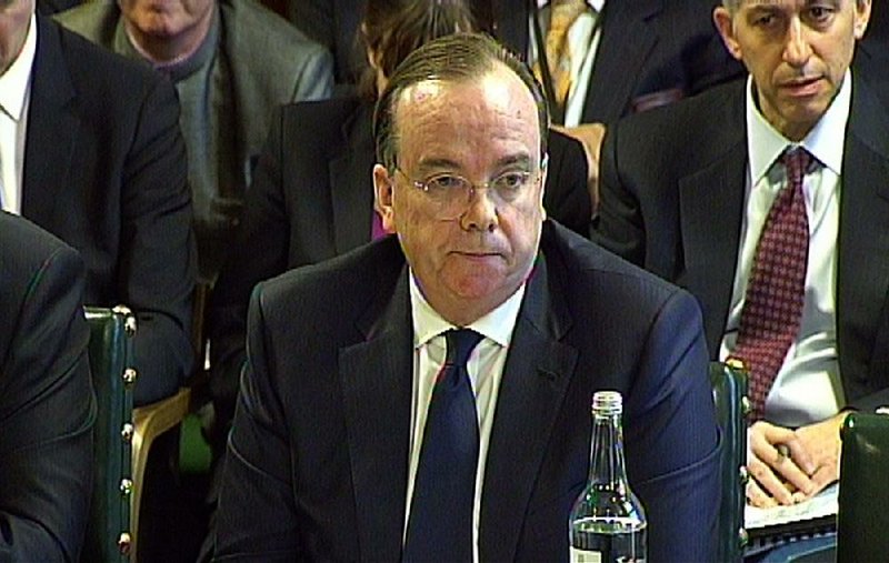In this image taken from TV, HSBC chief executive Stuart Gulliver answers questions in front of the Treasury Select Committee at the House of Commons, London over allegations that the bank's Swiss branch helped wealthy customers dodge tax, Wednesday Feb. 25, 2015.  HSBC, Europe's biggest bank, has endured a string of scandals — and paid millions in penalties to regulators around the world. But recent revelations that its Swiss private bank helped the wealthy evade taxes are raising new questions about HSBC's conduct and shining a spotlight on an industry still reeling from the 2008 financial crisis. 