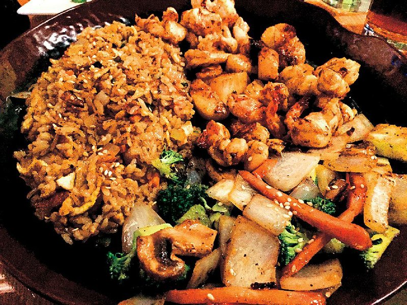 Treasures From the Sea, a hibachi entree of lobster tail, shrimp and scallops, is served with vegetables and fried rice at Sushi Cafe West. 