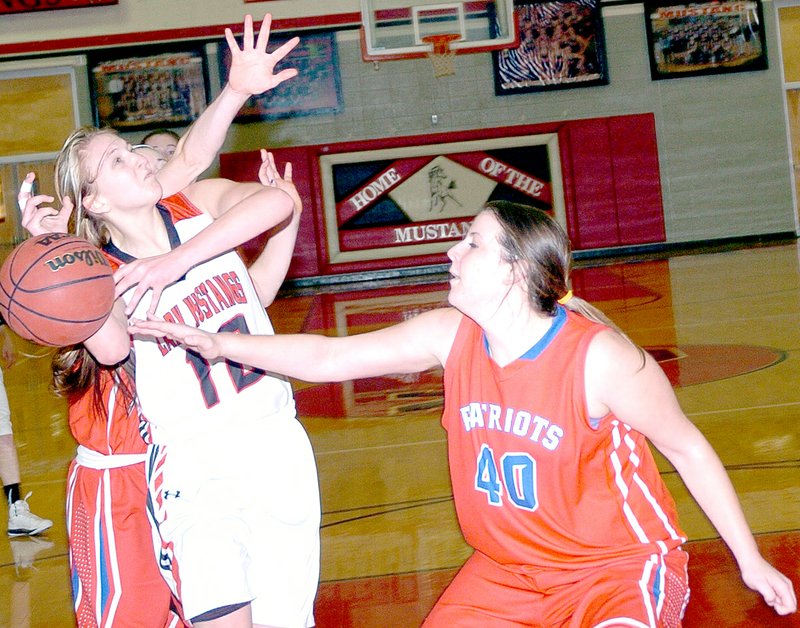 RICK PECK MCDONALD COUNTY PRESS McDonald County&#8217;s Baili Nelson gets fouled while going up for a shot during the Lady Mustangs 51-36 win Feb. 18 over East Newton at MCHS.