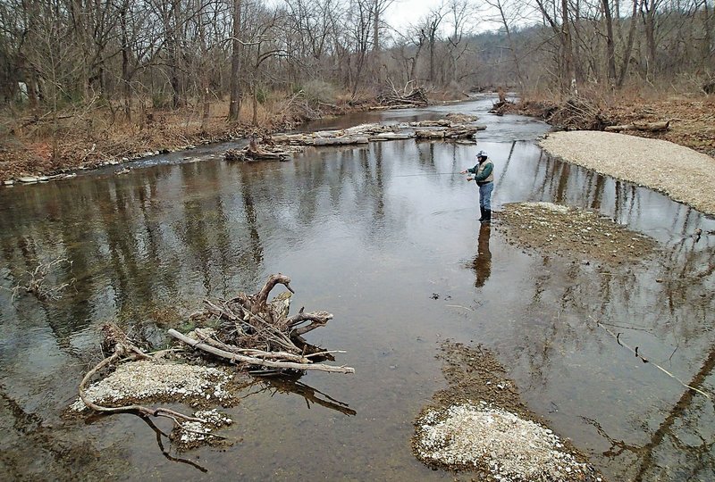 Russ Tonkinson fishes for trout Jan. 30 at Roaring River downstream from the boundary of Roaring River State Park. Trout can be caught the entire length of the stream.