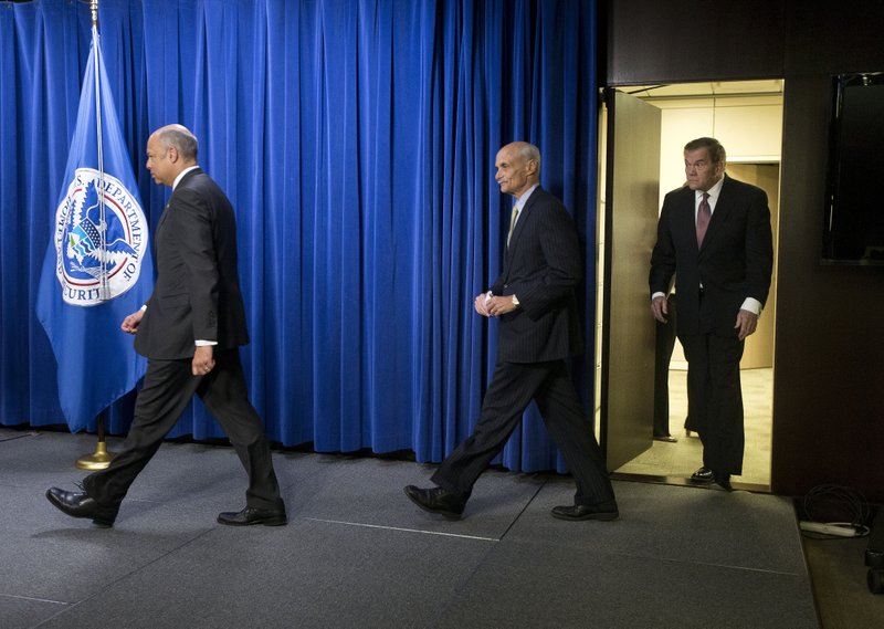 Homeland Security Secretary Jeh Johnson (left), followed by former Homeland Security secretaries Michael Chertoff and Tom Ridge, arrives Wednesday for a news conference in Washington. 