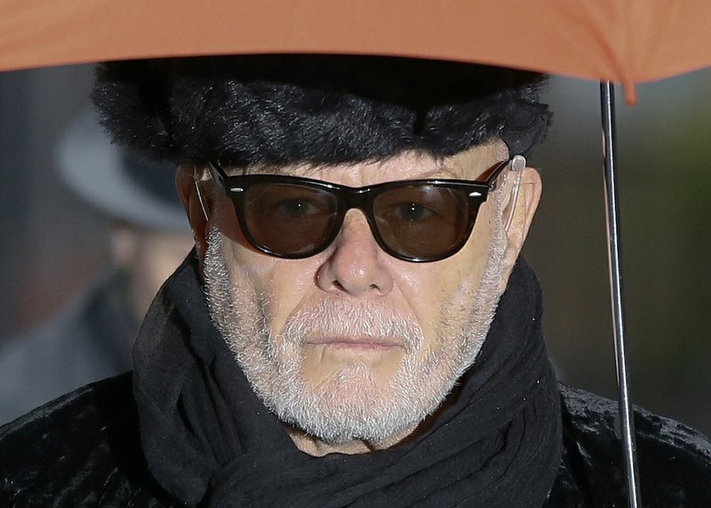 In this Thursday, Feb. 5, 2015, file photo, British pop star Gary Glitter, real name Paul Gadd, arrives at Southwark Crown Court in London. Gary Glitter has been jailed for 16 years for sexual assaults on three girls dating back to the 1970s. 