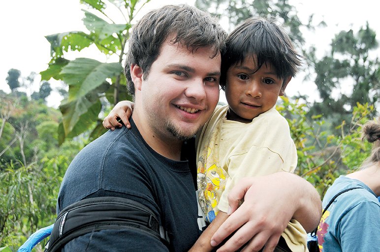 Ryan Cagle, left, hugs a young boy during a mission trip to Guatemala. Cagle went on the trip with a group from First United Methodist Church in Searcy.