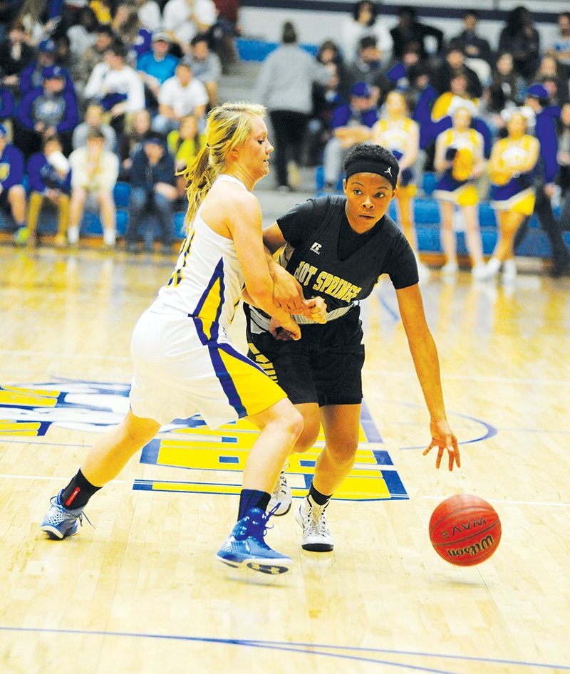 The Sentinel-Record/Mara Kuhn PLAY BALL: Hot Springs' Berniezha Tidwell (1) drives the ball as Lakeside's Karli Herron (21) defends during Thursday’s game at Lakeside. Tidwell scored 16 points as Hot Springs clenched the 5A-South title with a 50-21 victory.