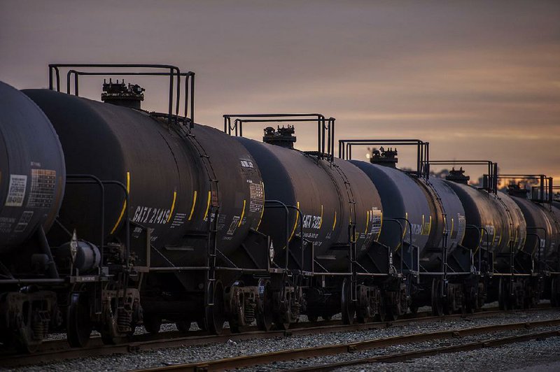 Oil tankers sit at a rail yard at the Kinder Morgan Inc. facility in Richmond, California, U.S., on Friday, Nov. 21, 2014. Crude-oil handling facilities at the end of rail lines from Albany, New York, to Richmond, California, are mired in lawsuits filed by community and environmental groups claiming they were kept in the dark about the projects. Photographer: David Paul Morris/Bloomberg