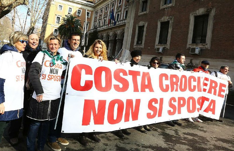 Protesters hold a banner reading in Italian "Don't move, Costa" in Genoa, Italy, Friday, Feb. 13, 2015. Costa Crociere‚Äôs chief executive is facing a public relations battle over the company‚Äôs future in Italy on the heels of the guilty verdict and 16-year sentence against former captain Francesco Schettino for deaths of 32 people in the 2012 shipwreck of the Costa Concordia. Costa‚Äôs German CEO Michael Thamm met Friday with Italy‚Äôs transport minister to offer assurances that the Italian cruise company owned by U.S. parent Carnival has no plans to move the headquarters out of Italy. Thamm was summoned to Rome after Costa announced it was moving four departments with 160 people from its Genoa headquarters to Hamburg, Germany.  Thamm said afterward that "Italy remains a market with huge potential." In Genoa, union members protested the announced transfers, saying they will weaken the company‚Äôs Italian identity. (AP Photo/Luca Zennaro, Ansa)