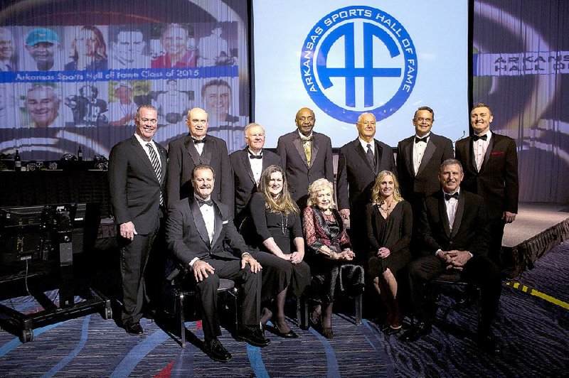 Twelve sports figures were honored with induction into the Arkansas Sports Hall of Fame on Friday at the Statehouse Convention Center in Little Rock. Ron Calcagni (front row from left) was joined by Carlin Reeder, who was accepting for her father Leon Clements; Carmen Fleck, who attended for her husband Jack Fleck; Christy Smith; Mike Malham Jr.; Stephen Jones (back row from left); Stan Lee; Eldon Hawley; Carl Jackson; Dwight Adams; Floyd Goodson, who attended for his grandfather Bowden Wyatt; and Pat Bradley.