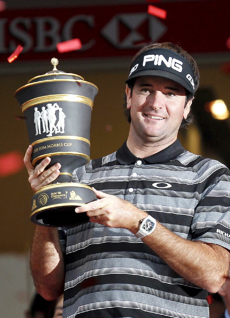 Bubba Watson of the U.S. celebrates with his champion trophy during the award ceremony of the HSBC Champions golf tournament at the Sheshan International Golf Club in Shanghai, China, Saturday, Nov. 9, 2014.  
