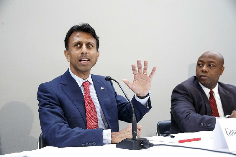 Louisiana Gov. Bobby Jindal talks about his plan for national education reform at a policy breakfast on Capitol Hill in Washington, Monday, Feb. 9, 2015. If he runs for president, Jindal is expected to make education a central part of his message with a focus on his opposition to Common Core. At right is fellow conservative Sen. Tim Scott, R-S.C.