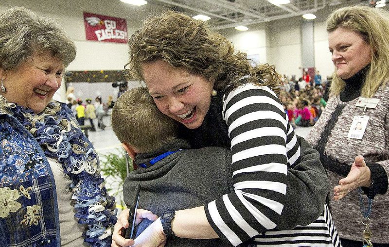 Don Roberts Elementary EAST program facilitator Carman McBride (center) celebrates after a surprise ceremony Thursday at the Little Rock school honoring her with a $25,000 Milken Educator Award. 