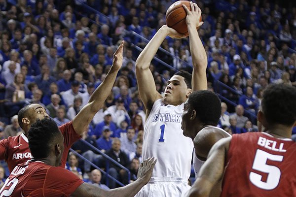 Kentucky's Devin Booker (1) shoots amid Arkansas defenders during the first half of an NCAA college basketball game, Saturday, Feb. 28, 2015, in Lexington, Ky. (AP Photo/James Crisp)