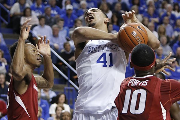 Kentucky's Trey Lyles (41) is fouled by Arkansas' Bobby Portis (10) as Anthlon Bell helps on the defense during the first half of an NCAA college basketball game, Saturday, Feb. 28, 2015, in Lexington, Ky. (AP Photo/James Crisp)