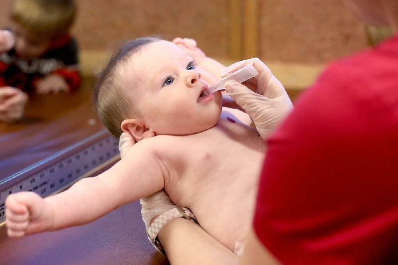 An oral vaccine is given to 6-month-old James Noland, of Salem, at Childhood Health Associates of Salem on Thursday, Feb. 12, 2015. Parents who want to maintain the right to refuse vaccinations for their children are mounting a strong fight against an Oregon bill that takes aim at the state’s highest-in-the-nation rate of non-medical vaccine exemptions. (AP Photo/Statesman Journal, Anna Reed)