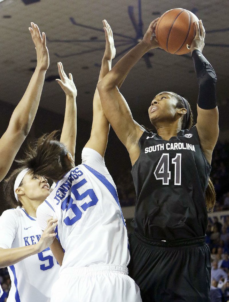 South Carolina's Alaina Coates (41) shoots while defended by Kentucky's Alexis Jennings (35) and Azia Bishop during the first half of an NCAA college basketball game, Sunday, March 1, 2015, in Lexington, Ky. (AP Photo/James Crisp)