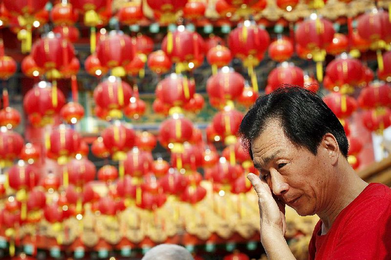 A Chinese family member of a passenger on board the missing Malaysia Airlines Flight 370, cries after praying at a temple in Kuala Lumpur, Malaysia, Sunday, March 1, 2015. Australia, Indonesia and Malaysia will lead a trial to enhance the tracking of aircraft over remote oceans, allowing planes to be more easily found should they vanish like Malaysia Airlines Flight 370, Australia's transport minister said Sunday. The announcement comes one week ahead of the anniversary of the disappearance of Flight 370, which vanished last year on a flight from Kuala Lumpur to Beijing with 239 people on board. No trace of the plane has been found. (AP Photo/Vincent Thian)