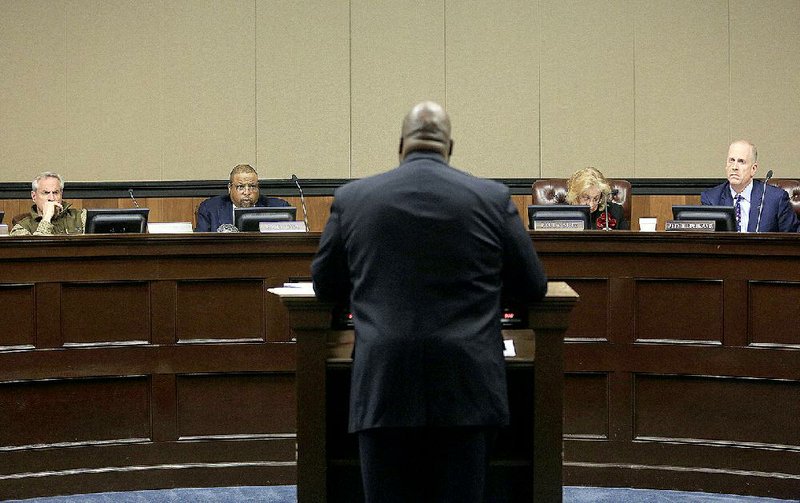 Arkansas Democrat-Gazette/STATON BREIDENTHAL --2/26/15-- Little Rock Police Chief Kenton Buckner (center) speaks Thursday afternoon about proposed police promotion guidelines at a Little Rock civil service commission meeting. 

