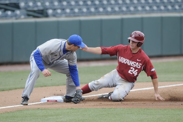 Arkansas' Chad Spanberger beats the throw to Eastern Illinois third baseman Brant Valach Monday, March 2, 2015.