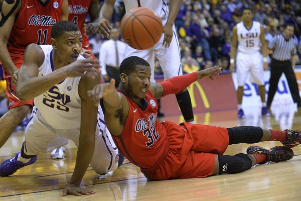 LSU's Jordan Mickey, left, goes to the floor against Mississippi guard Jarvis Summers (32) to clear the ball from under the LSU boards in the second half of an NCAA college basketball game Saturday in Baton Rouge, La., Saturday, Feb. 28, 2015. (AP Photo/The Baton Rouge Advocate, Travis Spradling)