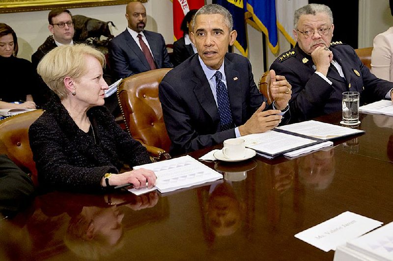 President Barack Obama, flanked by former Assistant Attorney General Laurie Robinson, left, and Philadelphia Police Commissioner Charles Ramsey, speaks during a meeting with members of the Task Force on 21st Century Policing, Monday, March 2, 2015, in the Roosevelt Room of the White House in Washington. (AP Photo/Jacquelyn Martin)