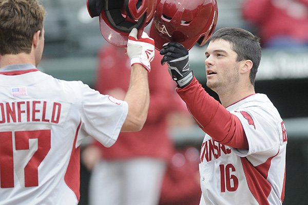 Arkansas' Andrew Benintendi (16) celebrates a fifth inning home run with Luke Bonfield during a game against Eastern Illinois on Tuesday March 3, 2015, at Baum Stadium in Fayetteville. 