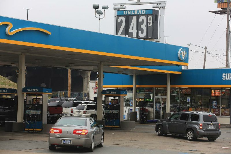 Motorists gas up Tuesday at a Valero station at East Broadway and Interstate 30 in North Little Rock. 