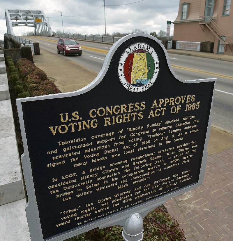 A national historical marker is seen with the Edmund Pettus Bridge in the background Tuesday in Selma, Ala.