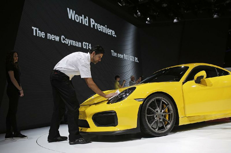 The new Porsche Cayman GT4 is presented to reporters Tuesday at the Geneva International Motor Show in Switzerland. The show opens to the public Thursday.